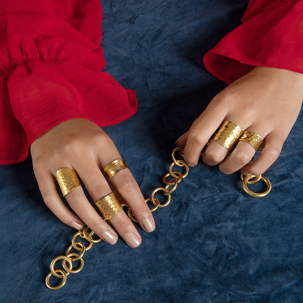 With a embossed texture that flatters and flows around the finger, the Nudo Gold Short Hammered Ring is size adjustable and handmade with sustainable 18k gold vermeil.