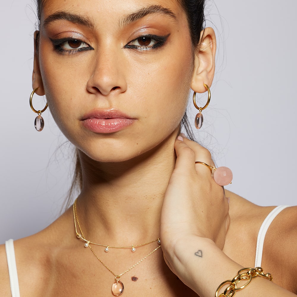 These gorgeous hoop earrings feature removable pink quartz charms. They are the ideal earrings to compliment any outfit. Wear them alone or with the matching Eden necklace. You can also add more charms such as pearl as seen on some of our images.