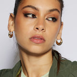 The Lola Large Moon Hoop Earrings are sculptural chunky earrings light enought to wear all day thanks to it's hollow center. These stunning gold sustainable earrings&nbsp; are moon shaped with a high polish 18k gold finish.