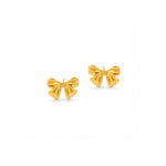 A pair of gold bow stud earrings with a textured, ribbed surface and post backs, displayed on a clean white background.