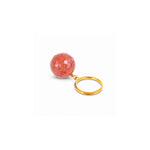 A faceted peach-pink stone keychain with a gold metal ring, shown on a plain white background.