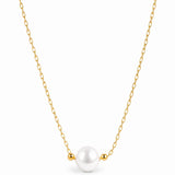 A delicate gold chain necklace featuring a single white pearl pendant flanked by two small gold beads, shown against a plain white background.