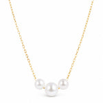 A delicate gold chain necklace featuring three white freshwater pearls arranged in a V-shape pendant, set against a clean white background.