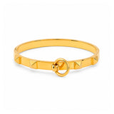 A polished gold bangle bracelet with a signature pyramid and ring design, shown on a clean white background.