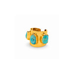 A wide gold cuff ring featuring three large, bezel-set oval turquoise stones, shown on a clean white background.