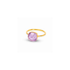 A gold ring with a faceted lavender purple cushion-cut gemstone, shown on a clean white background with a soft shadow.