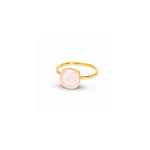 A gold ring with a round, pale pink cabochon gemstone, shown on a plain white background with a soft shadow.