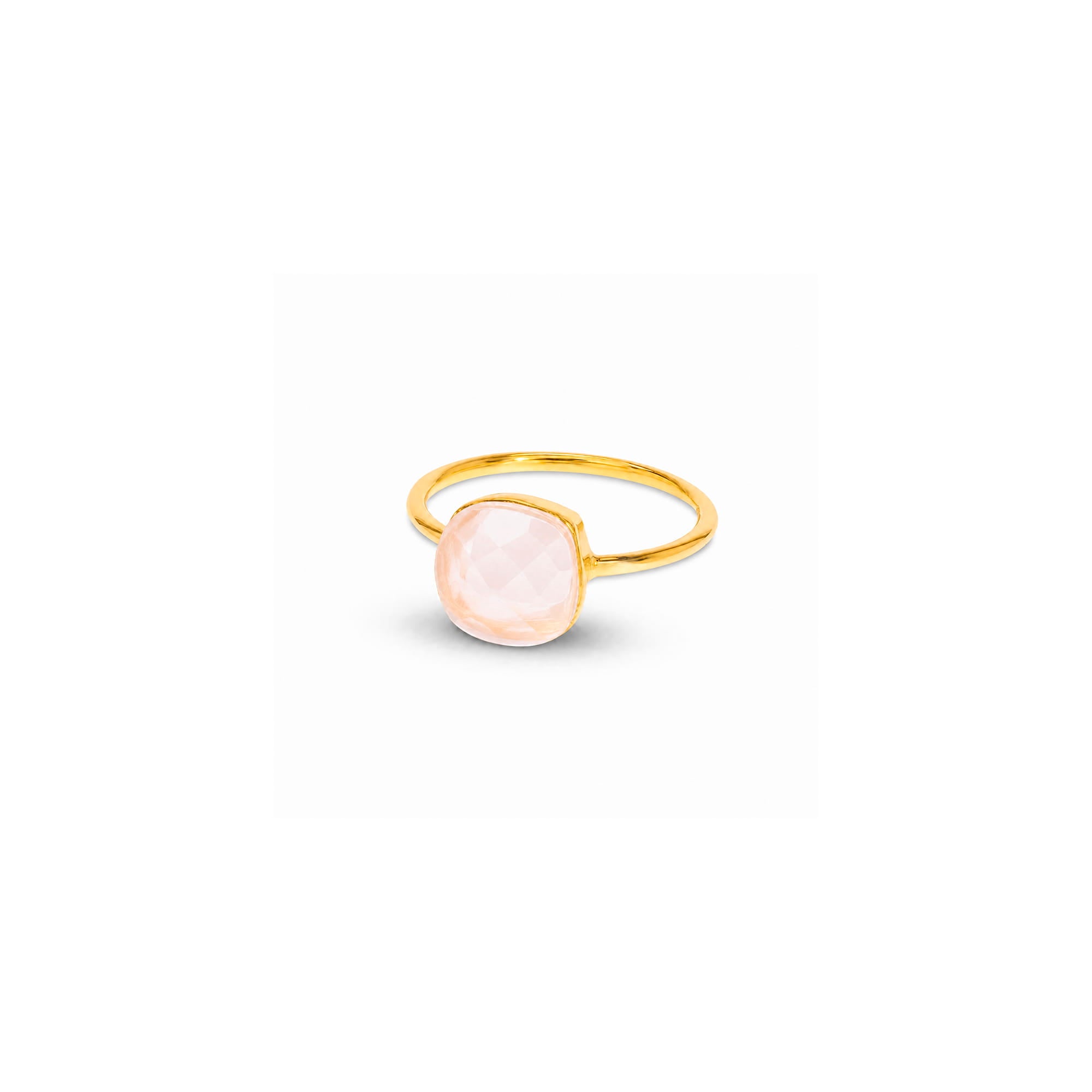 A gold ring with a round, pale pink cabochon gemstone, shown on a plain white background with a soft shadow.