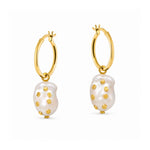 A pair of gold hoop earrings with irregular white baroque pearl drops, each accented with small gold studs, shown on a plain white background.
