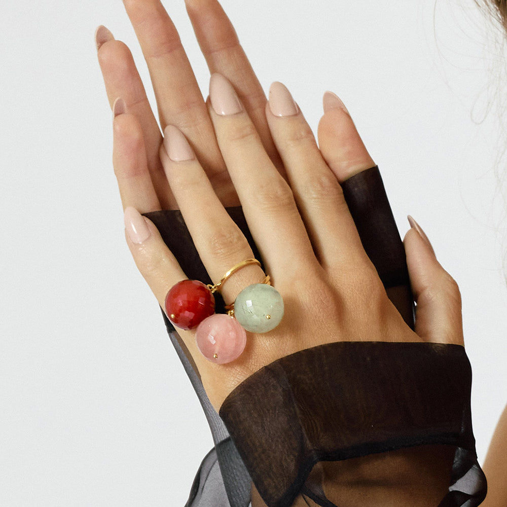 The Bubble Red Onyx Ring features a stunning pre-oned large round red gemstone, attached to a size adjustable gold ring. This allows the stone to move freely around your finger making this a unique ring. 