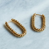 The perfect accessory for any outfit. Simple and stylish our Lilly Twisted Rectangular Gold Hoop Earrings are perfect for every day. Our sustainable earrings are handmade with recycled brass dipped in thick layers of recycled 14 Carat Gold.