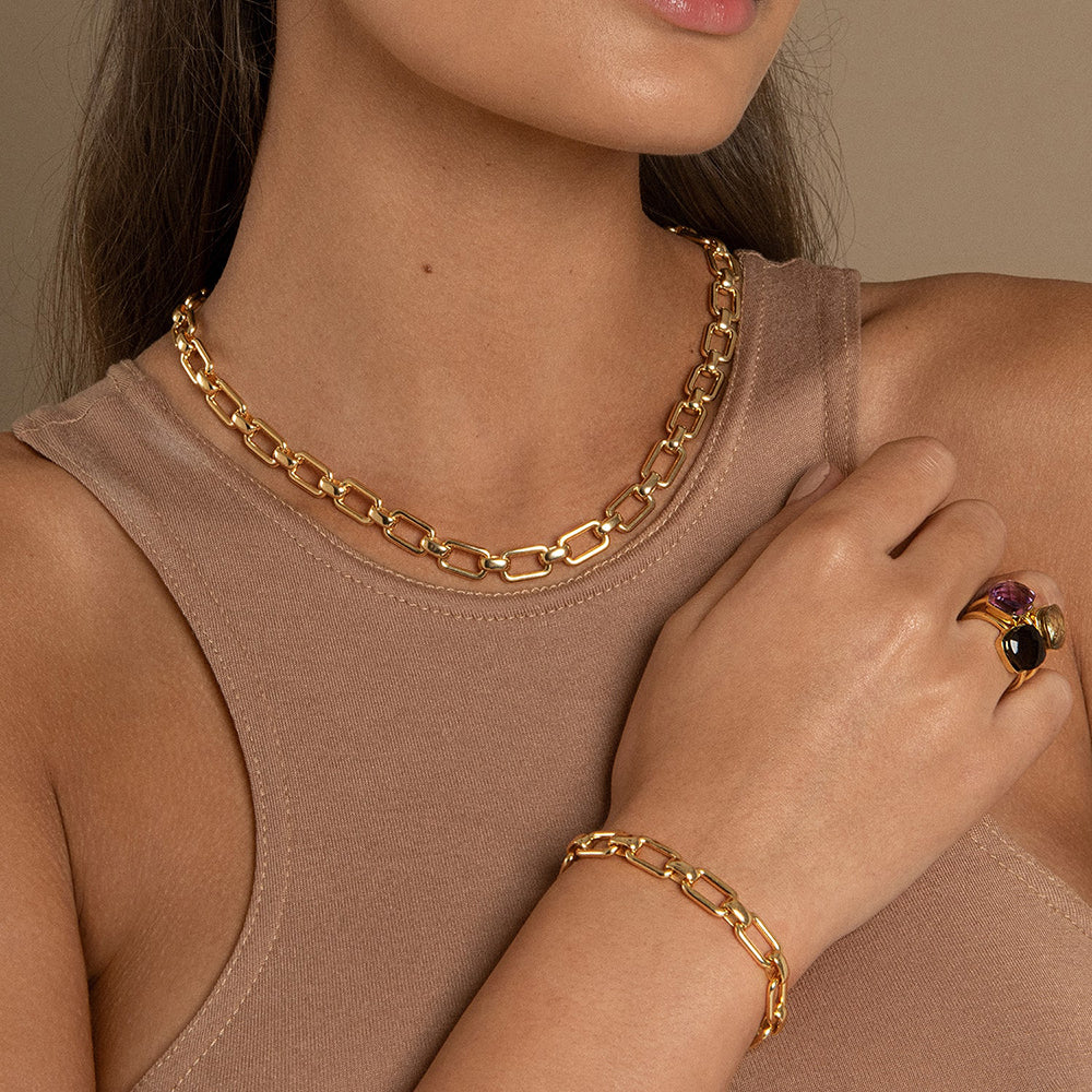 The Daphne Gold Bracelet is a true statement piece featuring a chunky link chain designed to lay flat and maximize the gleam of the hand-polished gold. The sustainable materials are 14 Gold Vermeil which is recycled sterling silver heavily dipped in recycled 14 Carat gold.